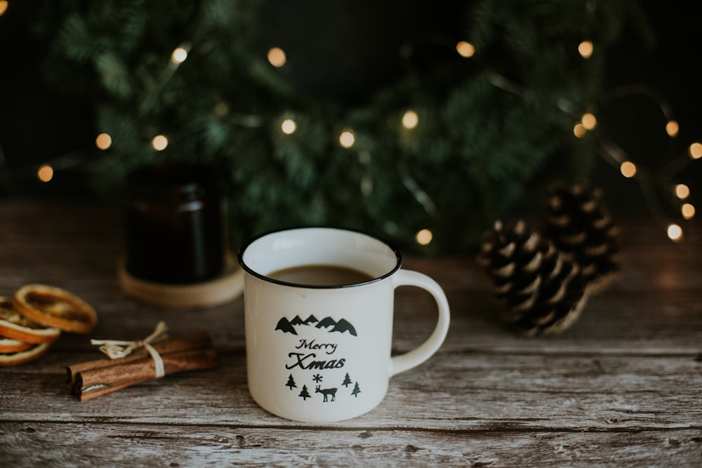 white ceramic mug on brown wooden table