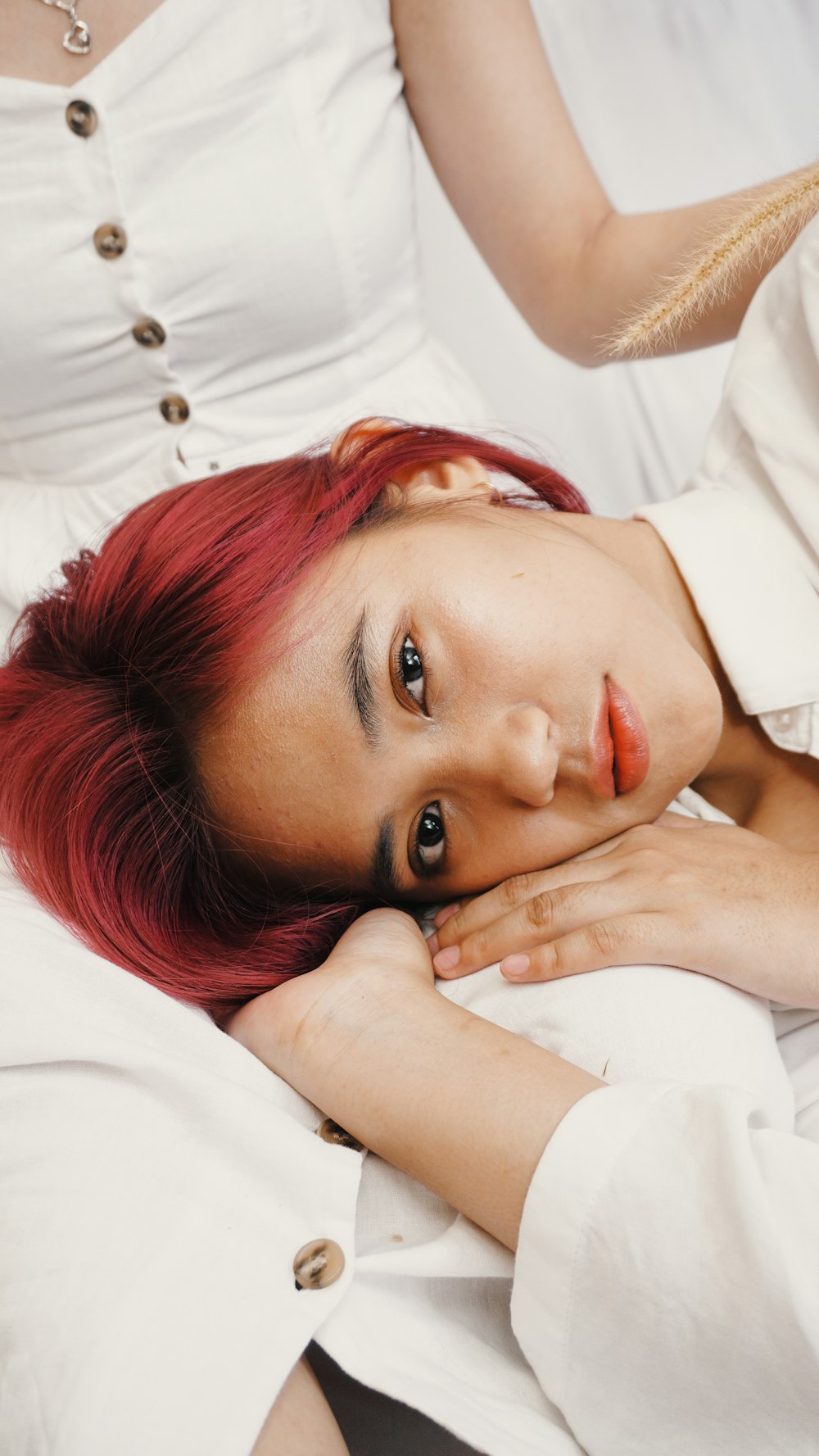 woman in white dress shirt lying on bed