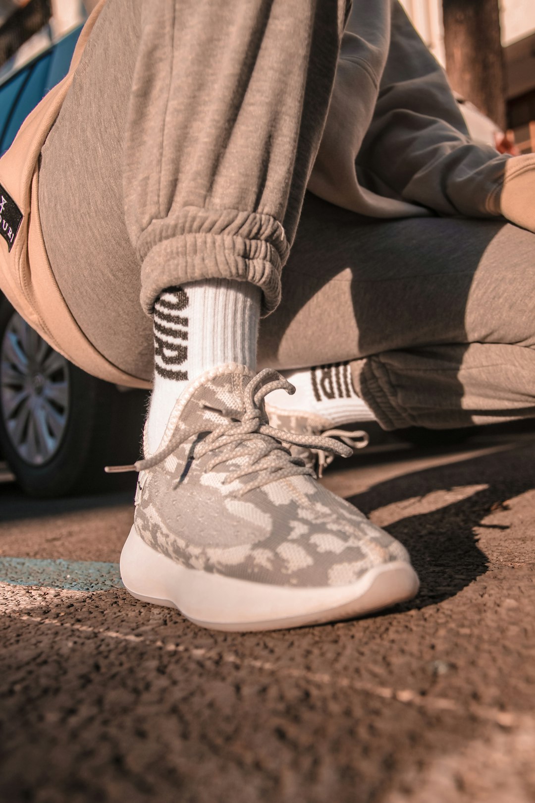 person wearing gray and white nike sneakers