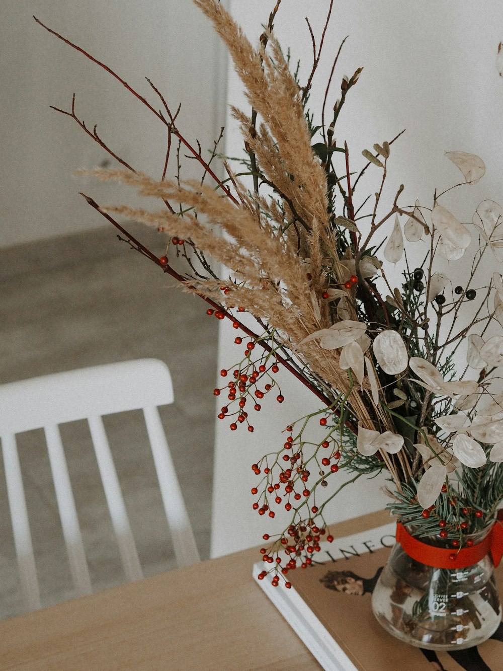 white flowers on red vase