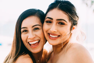 Portrait of two smiling Dominican sisters standing in their inviting, colorful beauty salon.