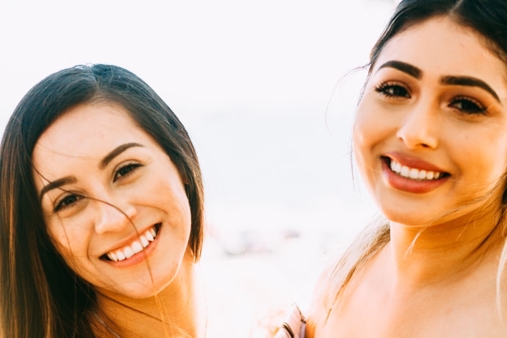 smiling woman in white tank top