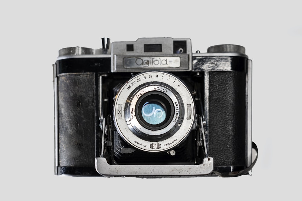 black and silver camera on white surface