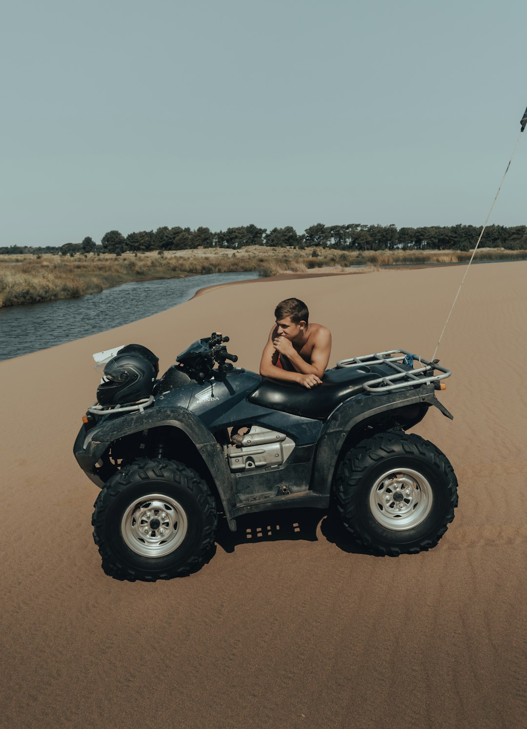 woman in black and white jeep wrangler on brown sand during daytime