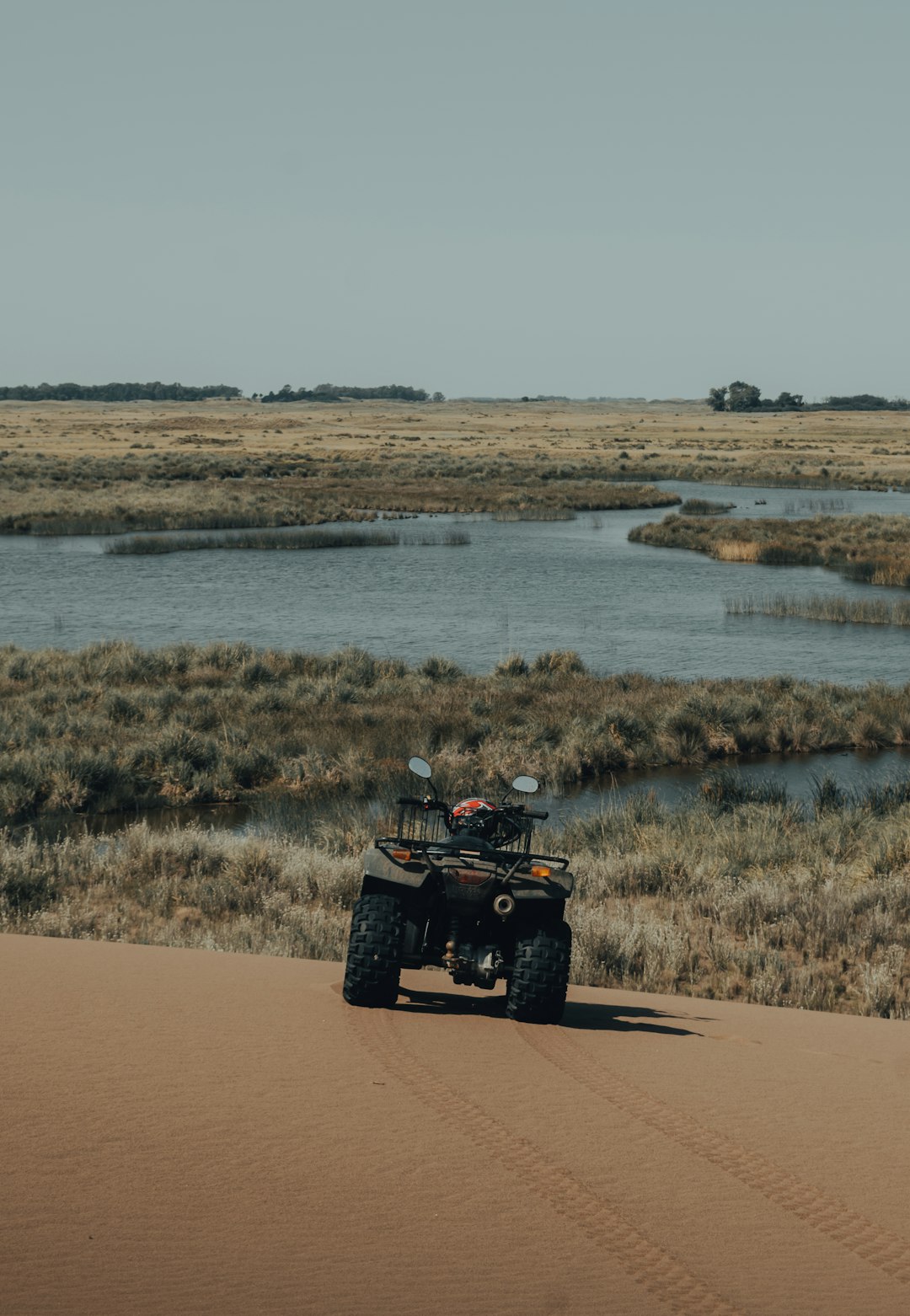 yellow and black atv on brown field during daytime