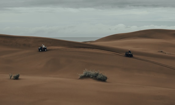 3 cars on desert during daytime
