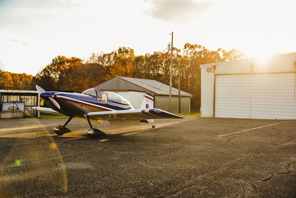 blue and white airplane on gray asphalt road during daytime