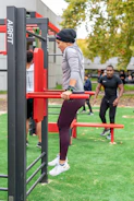 Focused athlete doing controlled dips wearing fitted compression shirt.