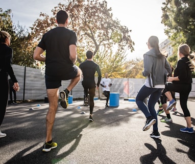 man in black t-shirt and black shorts running on road during daytime