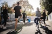 man in black t-shirt and black shorts running on road during daytime