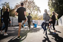 Participants collaborating enthusiastically during an outdoor bootcamp session under the bright UAE sun.