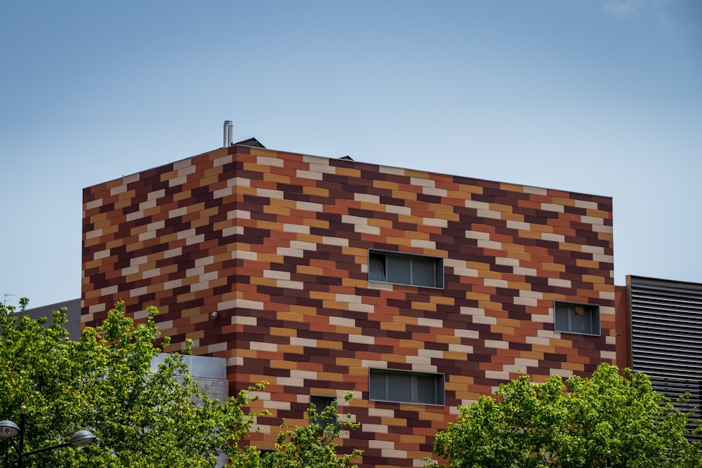 brown brick building near green trees during daytime