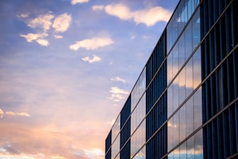 black and white building under cloudy sky