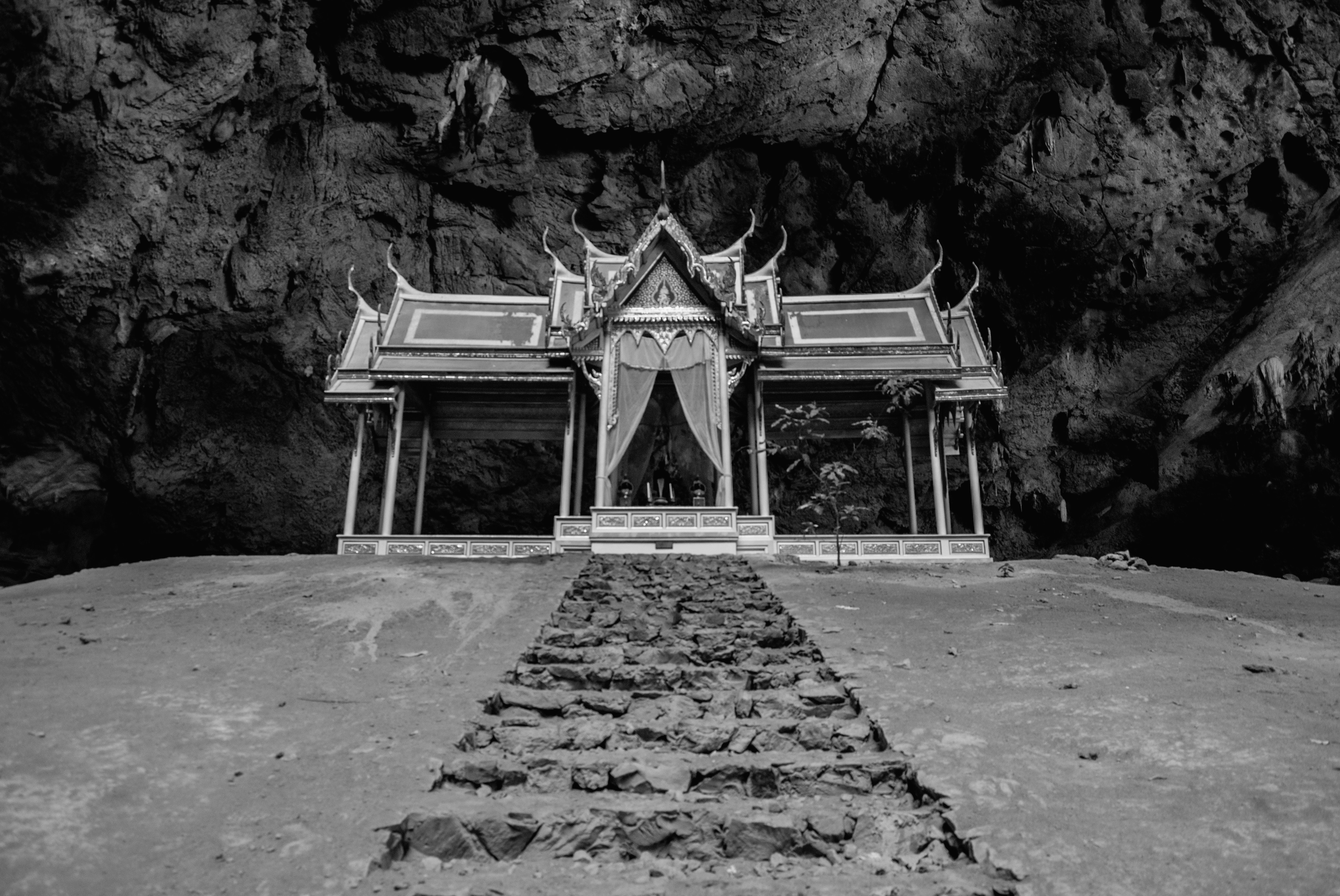 grayscale photo of concrete pathway buddhist temple teams background