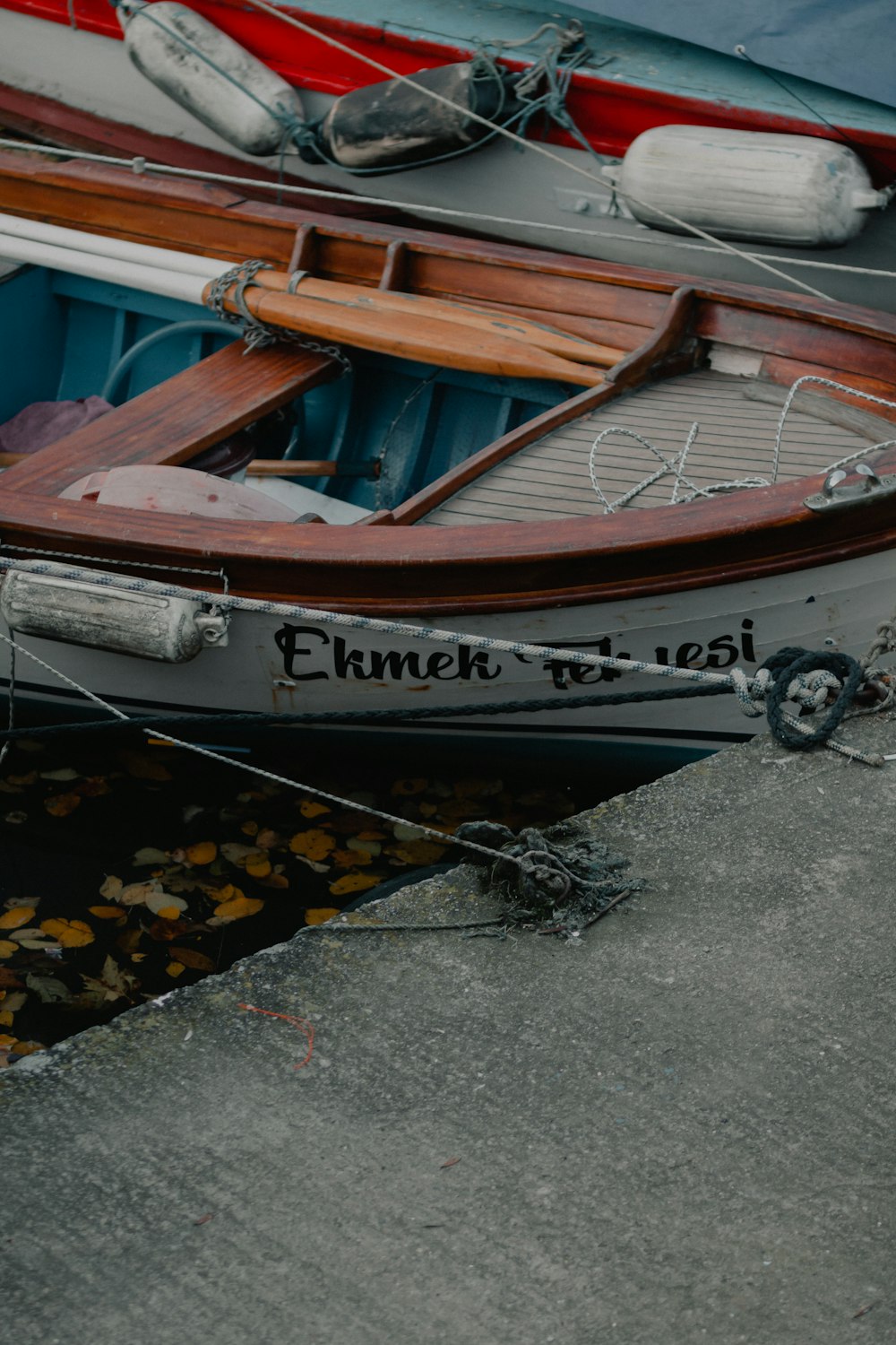 brown and white boat on gray concrete floor