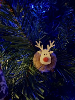Flat LED reindeer decoration hanging on a decorated Christmas tree.