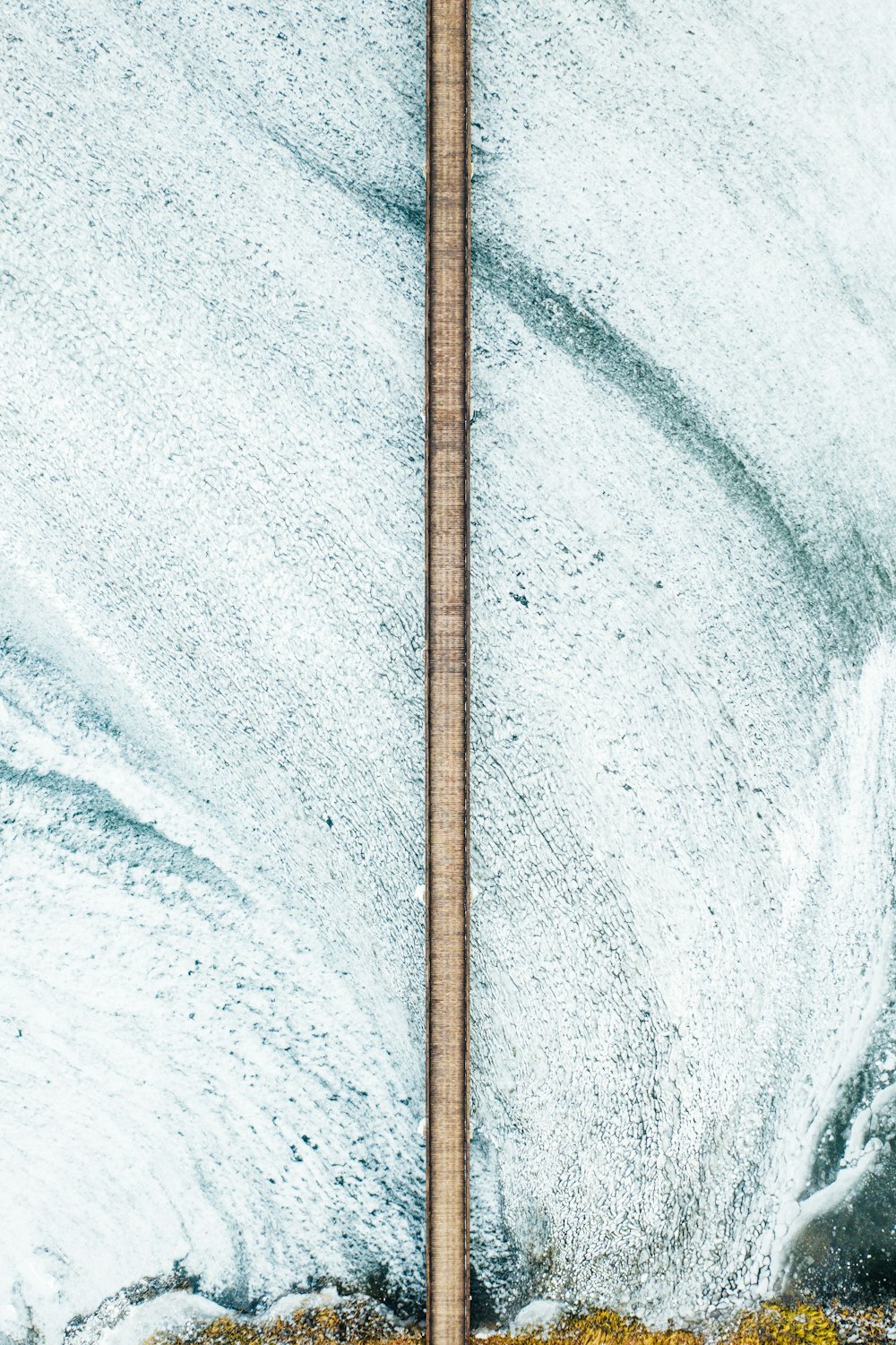 brown wooden stick on white and blue water