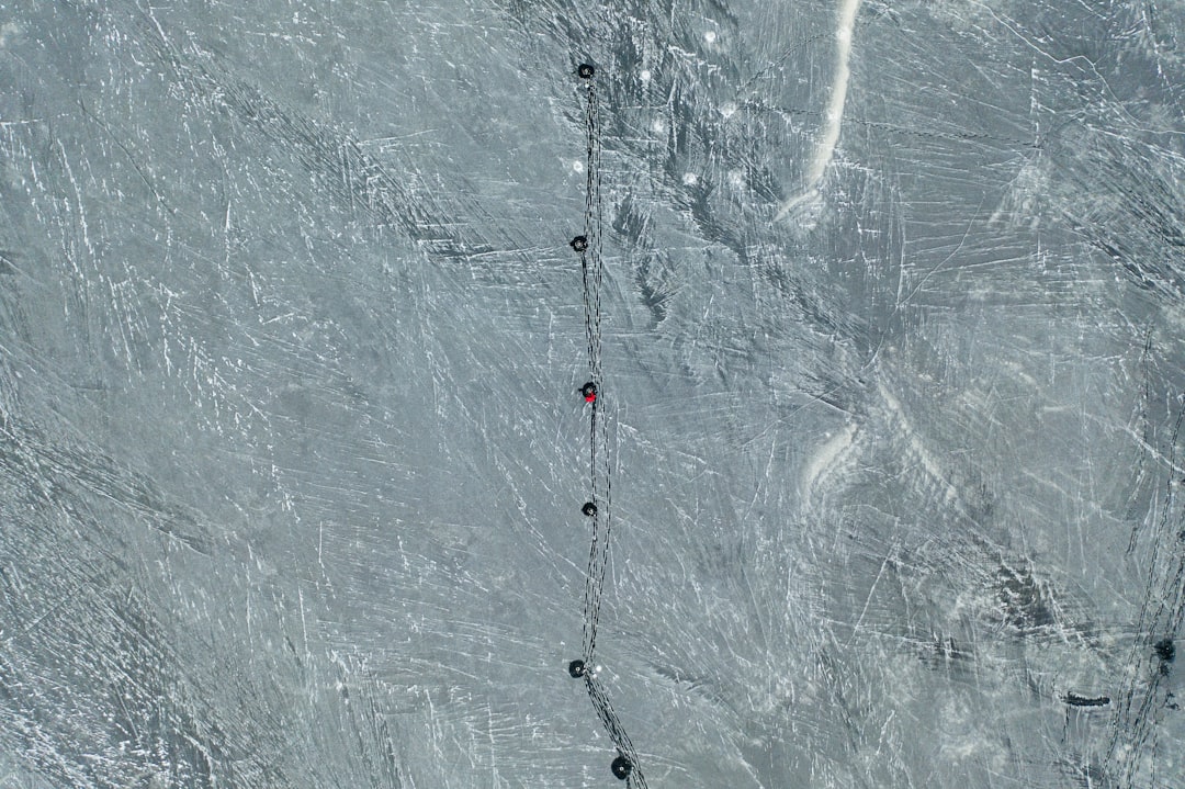 white and red rope on gray concrete wall