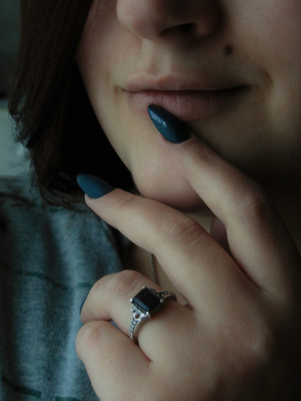 woman with blue manicure wearing silver ring