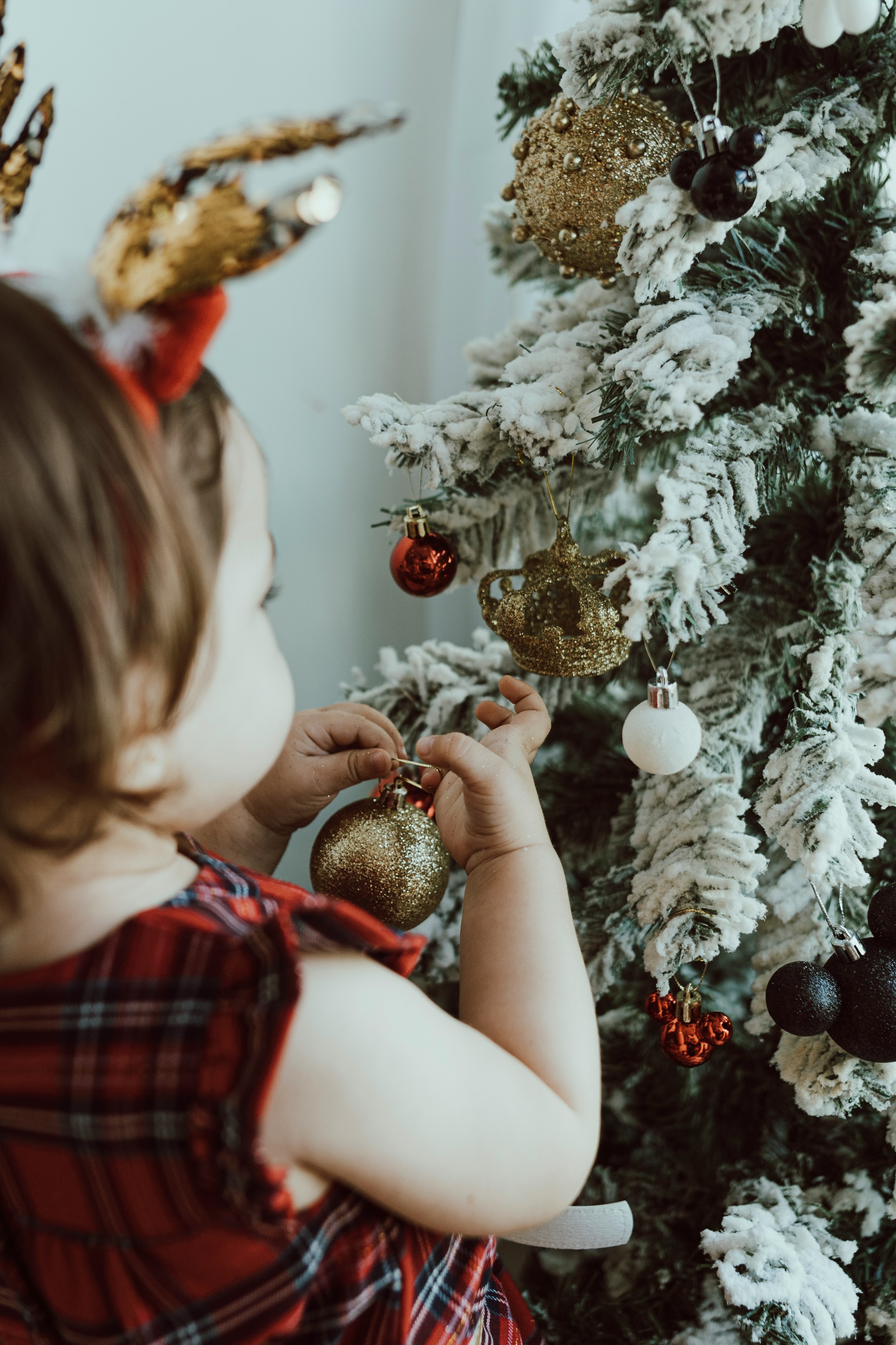 Kid decorating Christmas tree | December