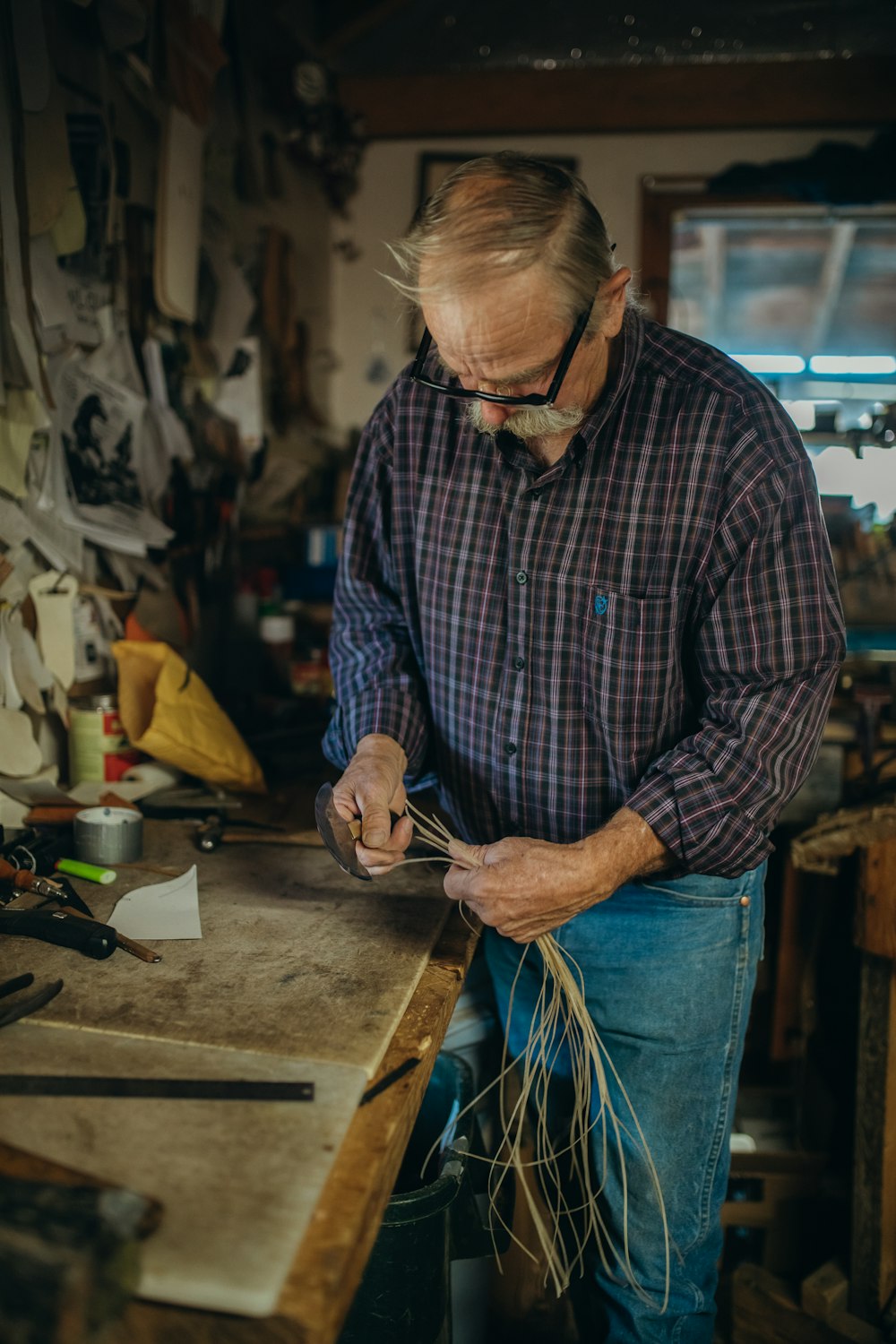 man in blue denim jeans and plaid dress shirt