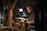 A friendly handyman working on home repairs in a well-lit living room.