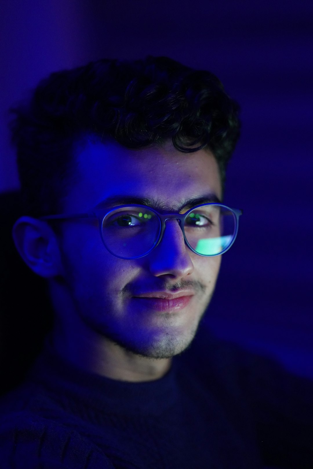 man in black crew neck shirt wearing eyeglasses