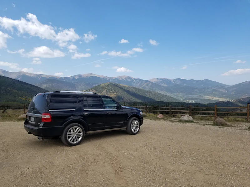 Black SUV parked in an open field