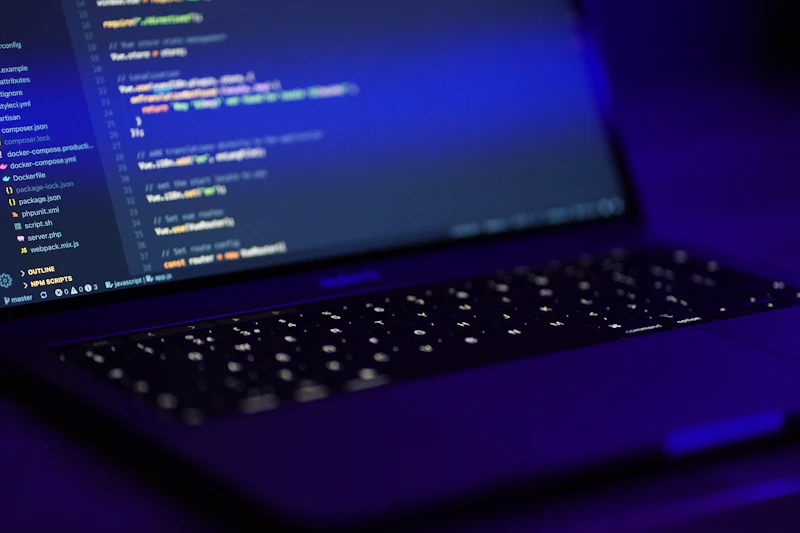 Laptop with code on screen in blue light