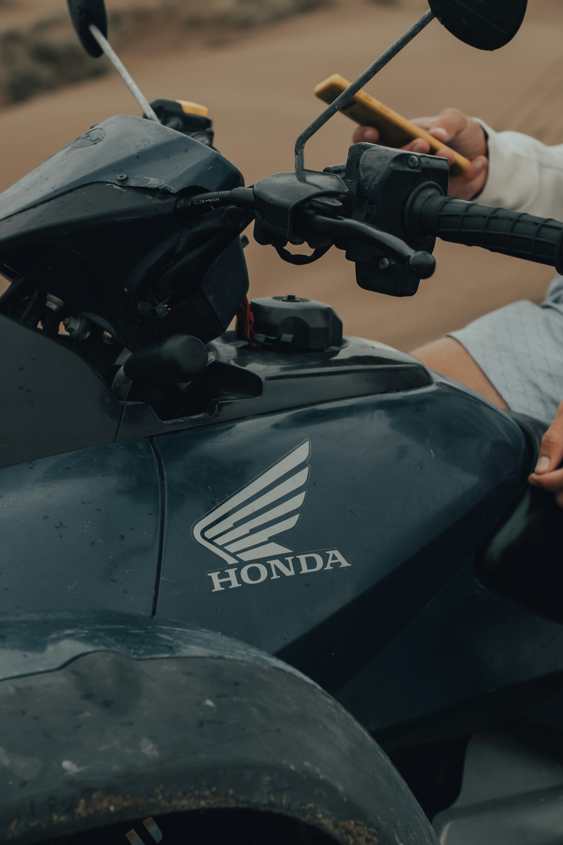 black honda motorcycle on brown floor