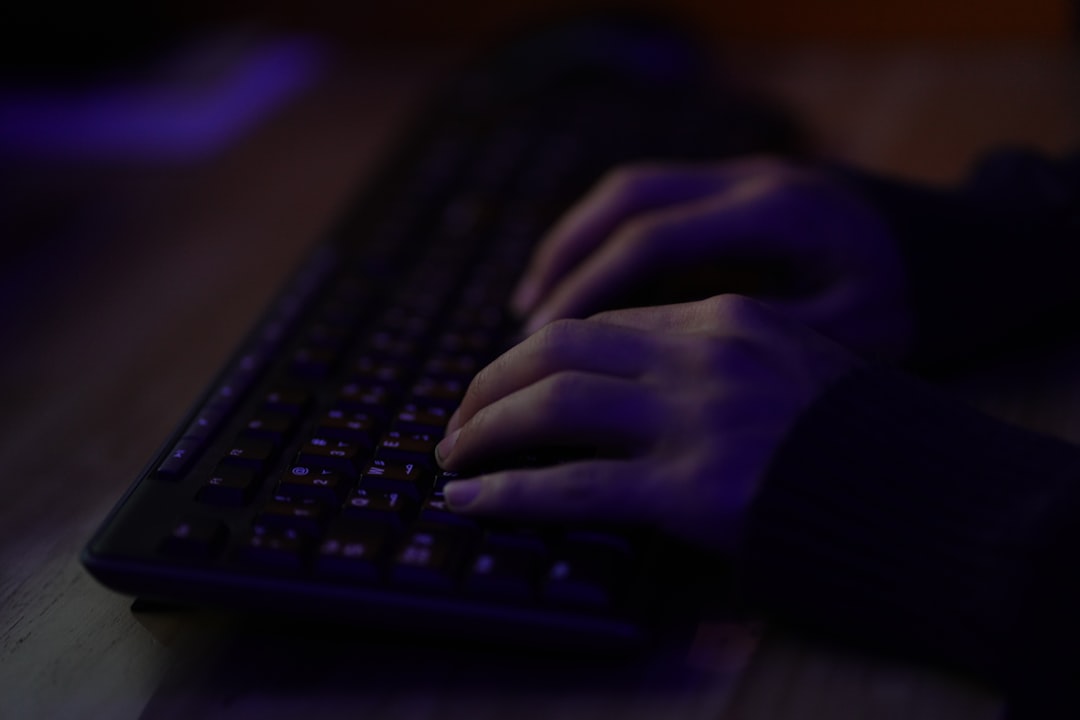 persons hand on black computer keyboard