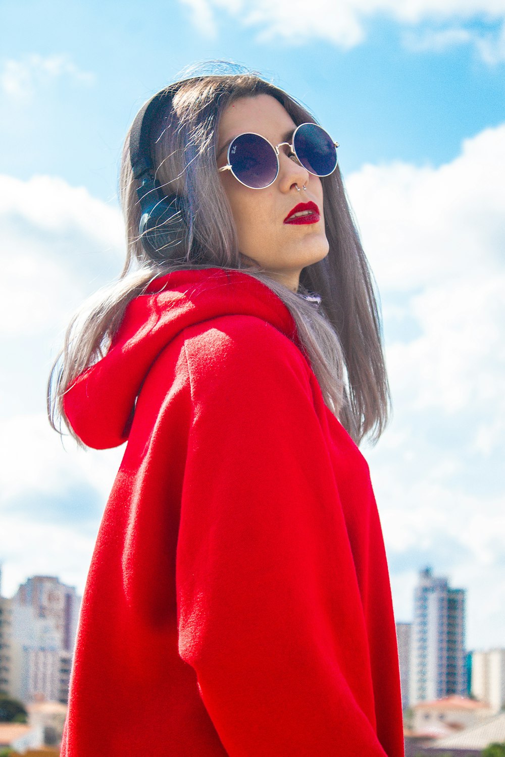 woman in red sweater wearing black sunglasses