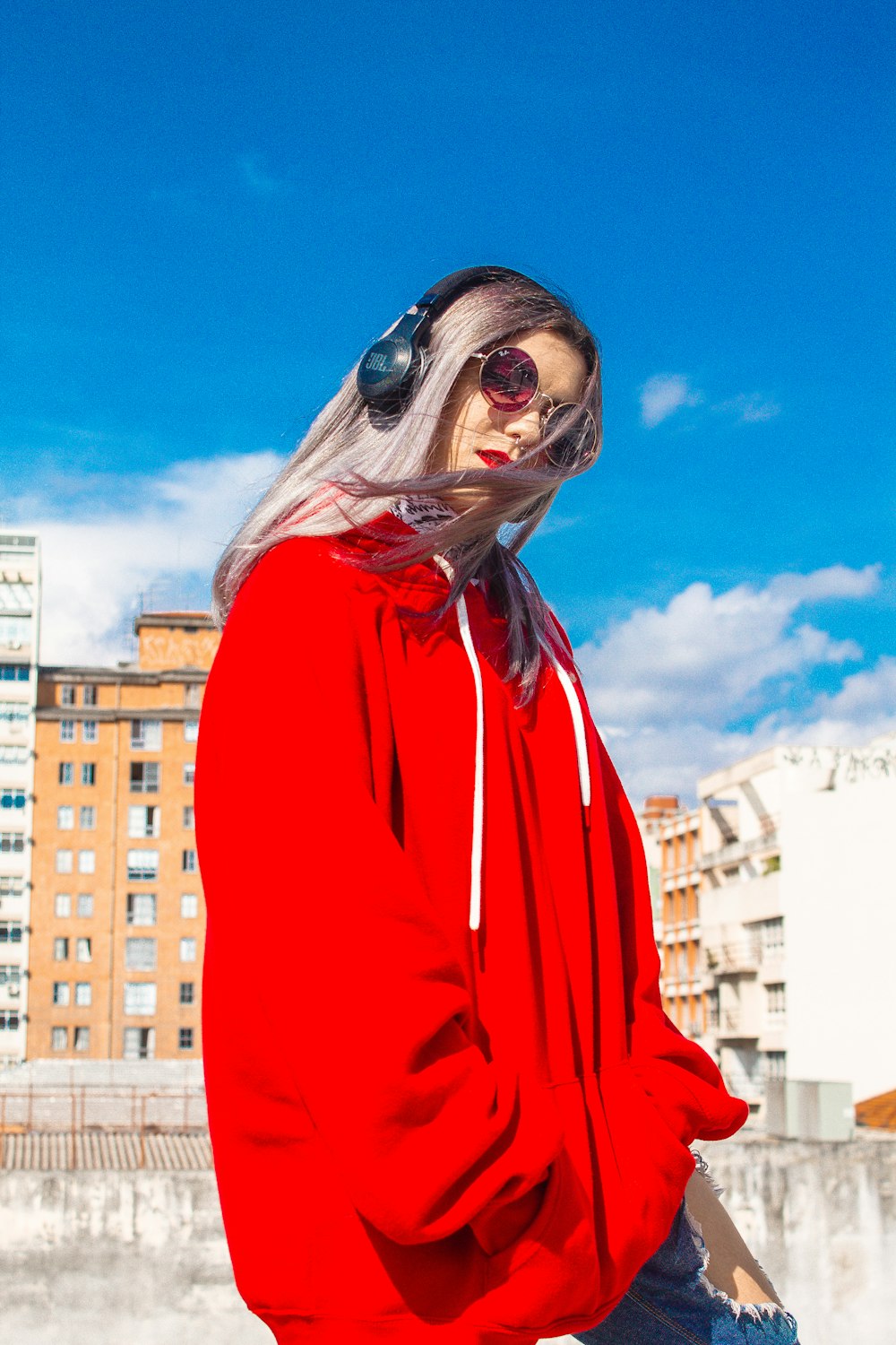 woman in red long sleeve shirt wearing black sunglasses