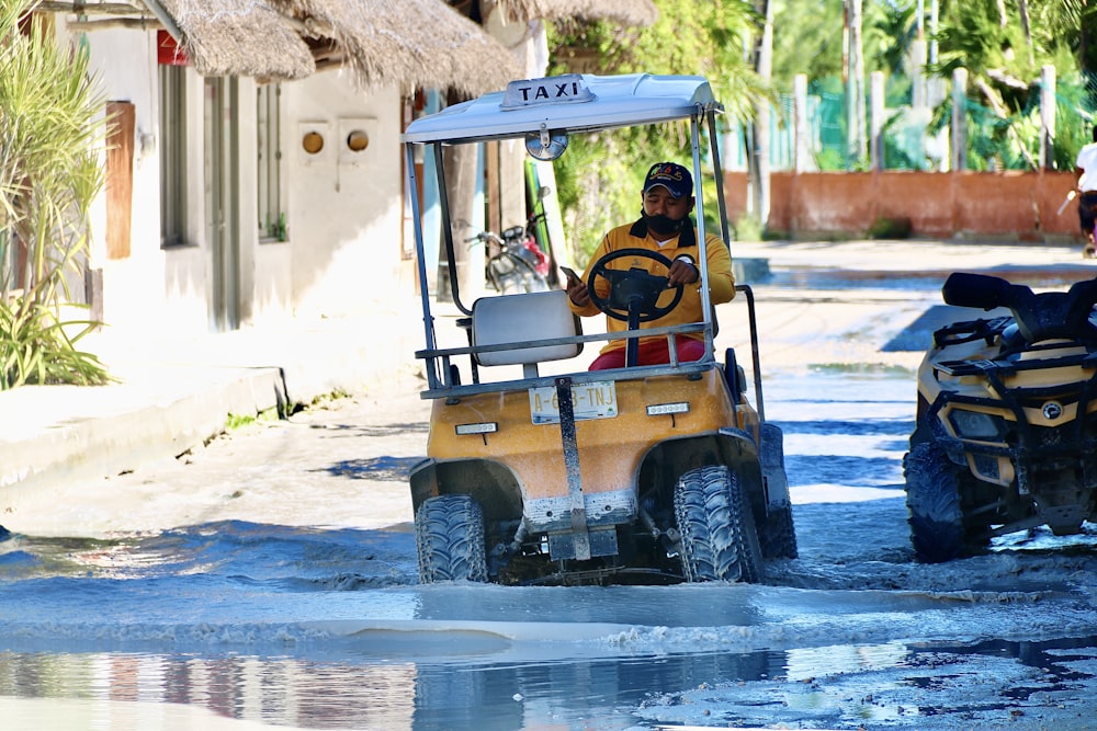 yellow and black golf cart on white sand during daytime