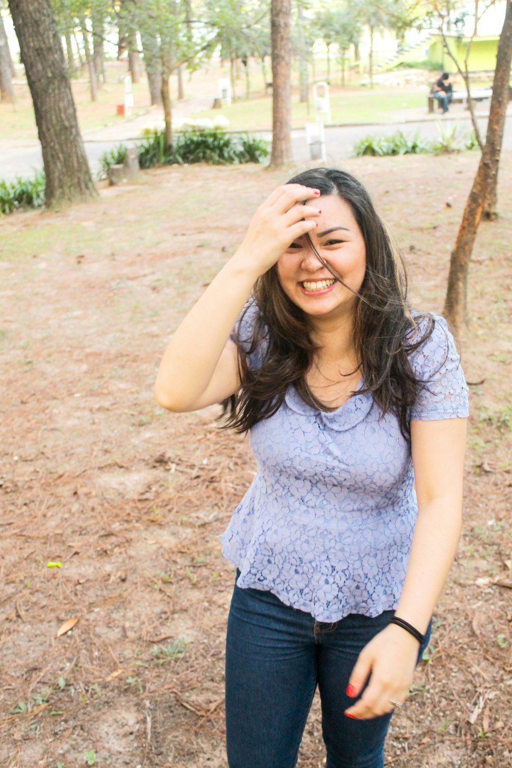 woman in gray crew neck t-shirt and blue denim shorts standing on brown soil during