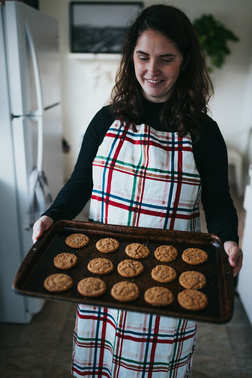 woman in black cardigan holding chocolate cake