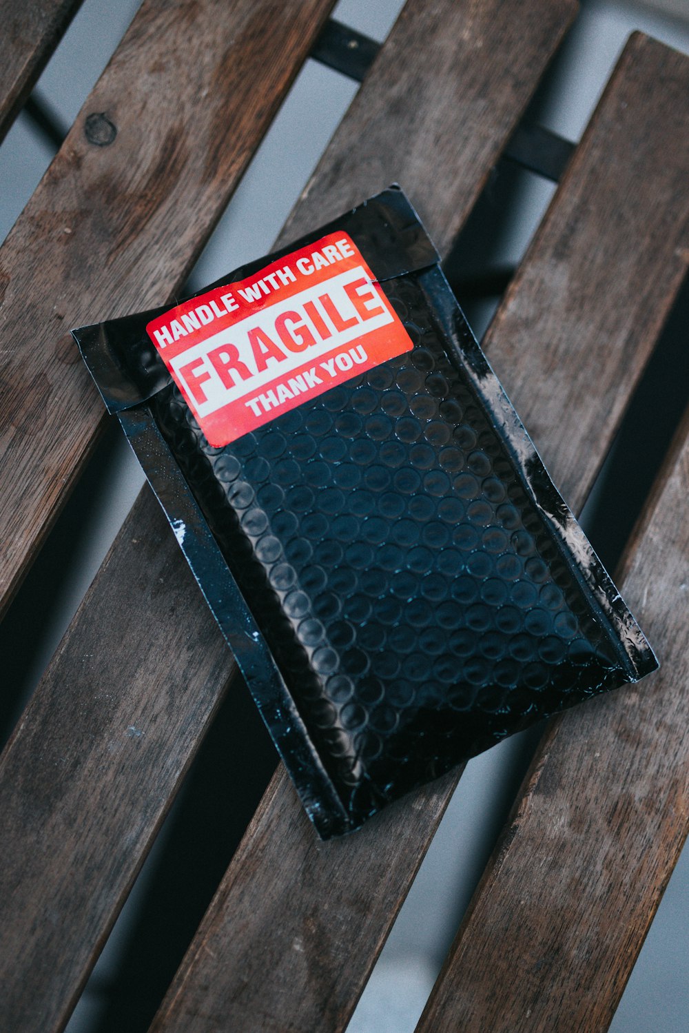 a wallet sitting on top of a wooden bench