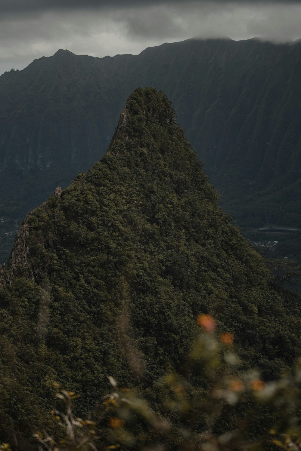 green mountain beside body of water during daytime