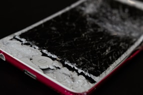 Before and after images showing a phone with a shattered screen and the same phone fully repaired.