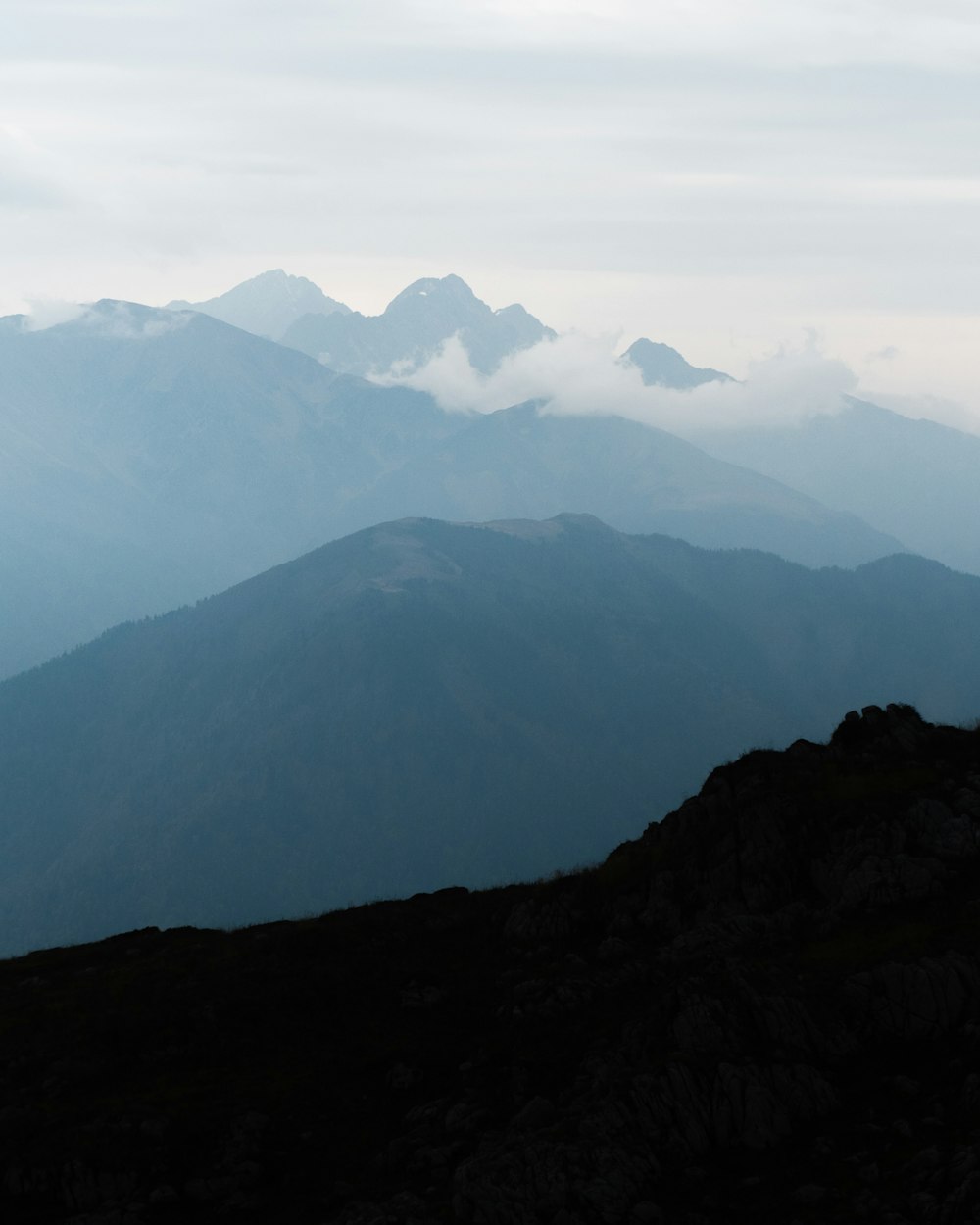 black and white mountains under white sky during daytime