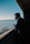 man in black jacket and black knit cap standing on dock during daytime