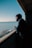 man in black jacket and black knit cap standing on dock during daytime