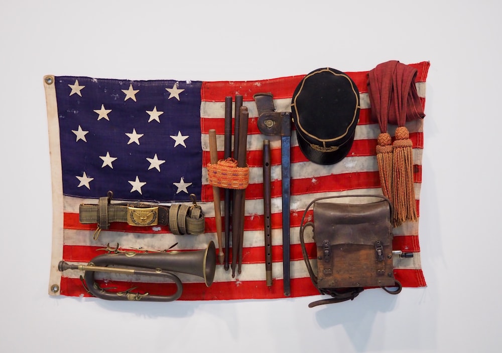 us a flag beside brown leather handbag