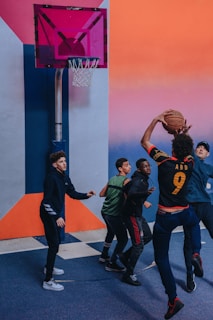 A group of diverse players practicing basketball on an outdoor court.