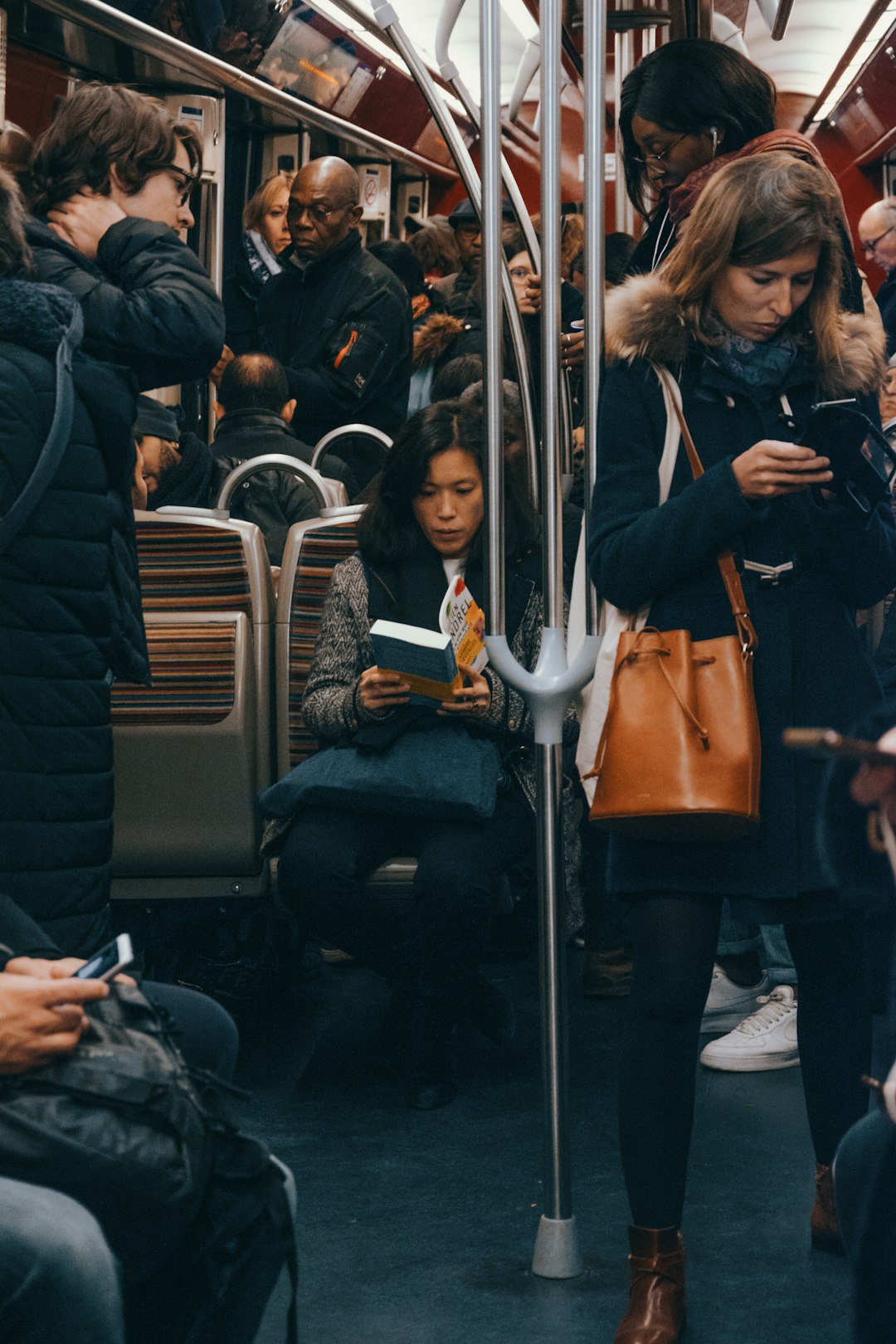woman in black jacket sitting on train seat