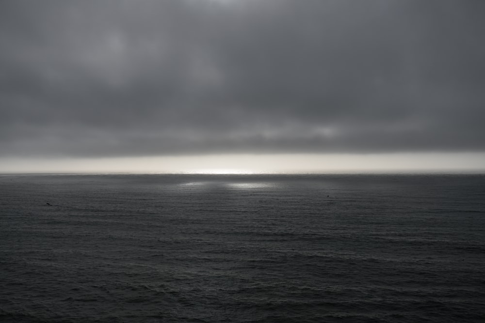 body of water under cloudy sky during daytime