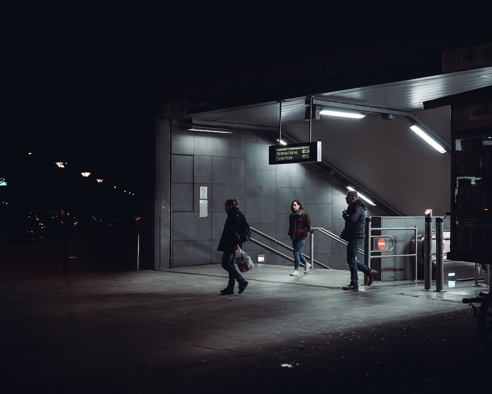 man in black jacket walking on hallway