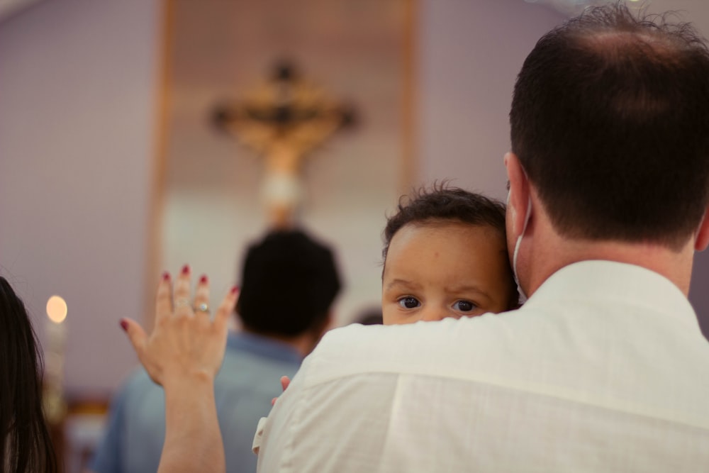 boy in white shirt raising his hands