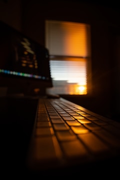 Close-up of hands typing on a keyboard with soft morning light