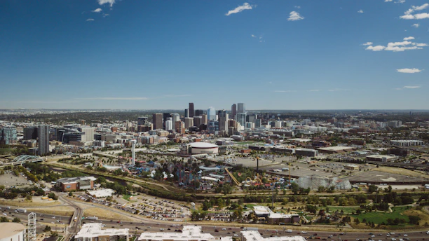 A vibrant panoramic view of Qiddiya City’s amusement parks under a clear blue sky.